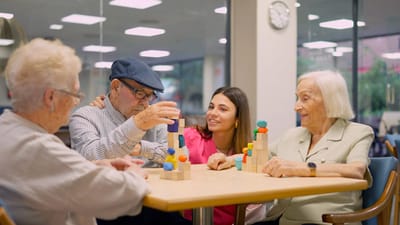 Residents and staff enjoying a building blocks activity