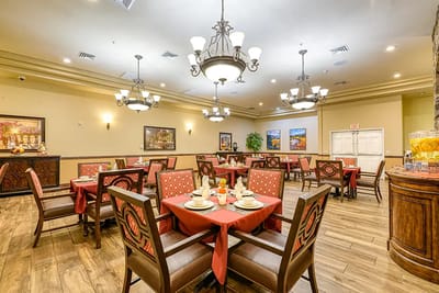 Dining room setup with tables and chairs for residents