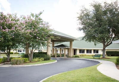 Exterior view of Lake Bennet Center with gardens and pathway
