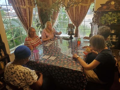 Residents playing bingo in a bright common area