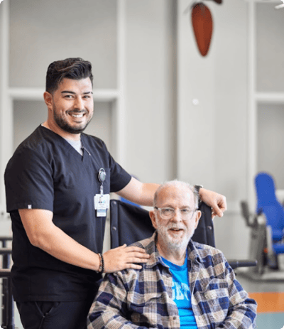 Staff member with a resident in a bright interior space