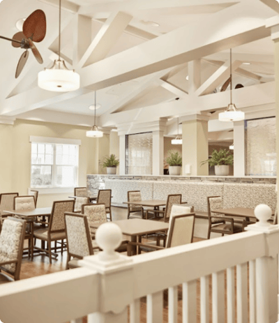 Bright dining area with wooden tables and chairs