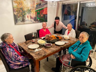 Residents enjoying a meal together in the dining room