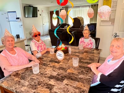 Residents celebrating a birthday in a common area