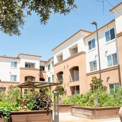 Modern senior living building with garden area