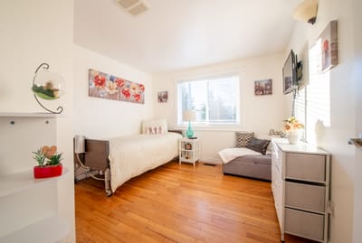 Bright and modern resident room with wood flooring