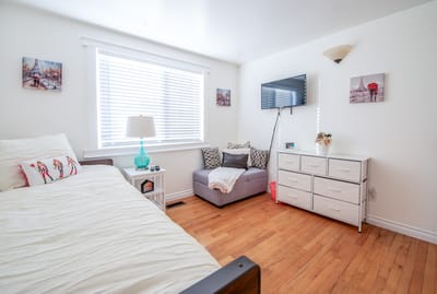 A private resident room with a bed and seating area