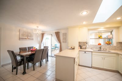 Bright kitchen and dining area with table and modern decor