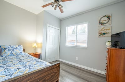 A well-furnished resident room with a bed and decorative items