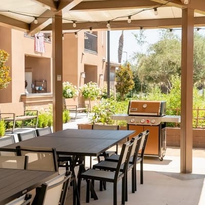 Outdoor dining area with a grill and tables