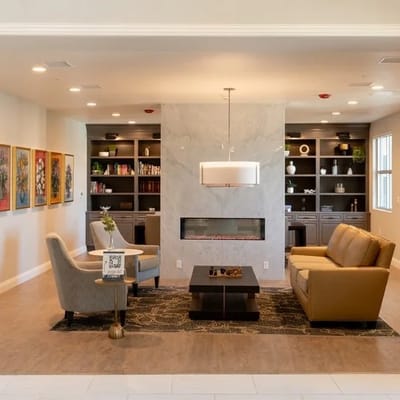 Cozy common area with seating and bookshelf