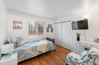 A cozy interior of a resident's room with a bed and decor