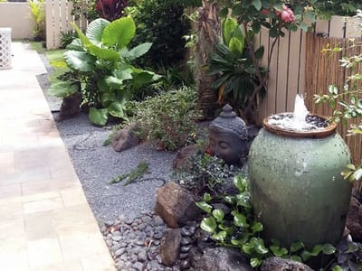 A peaceful outdoor garden area with plants and a fountain