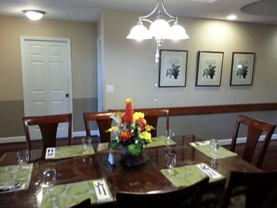 Bright dining room set for a meal with floral centerpiece