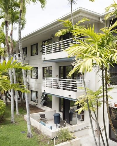 Exterior view of Lani Huli Elderly Apartments surrounded by palm trees