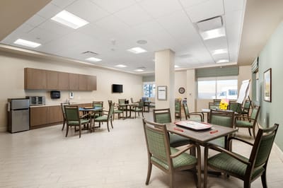 Interior common area with dining tables and kitchen