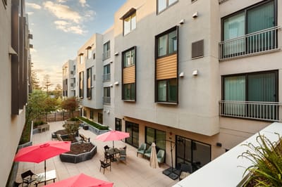Outdoor courtyard area with seating and umbrellas