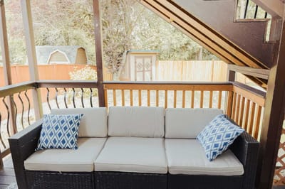 Outdoor porch with seating and decorative pillows
