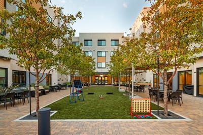 Outdoor courtyard with trees and seating areas