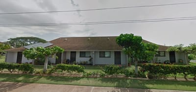Front view of DE Thompson Village showing residential buildings and landscaping.