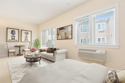 Cozy resident room with seating area and natural light