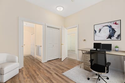 Spacious interior of a resident room with desk and chair