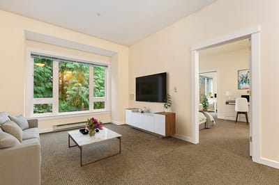 Bright interior of a resident living room with large windows