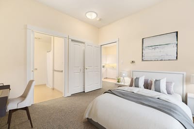 Bright resident room with a bed and kitchenette