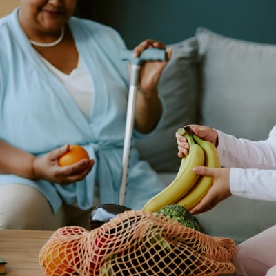 Residents sharing fresh fruits in a common area