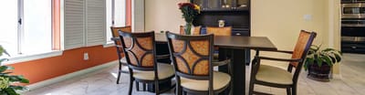 Bright dining area with chairs and flowers
