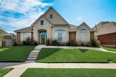 Exterior view of a senior living facility with a landscaped yard