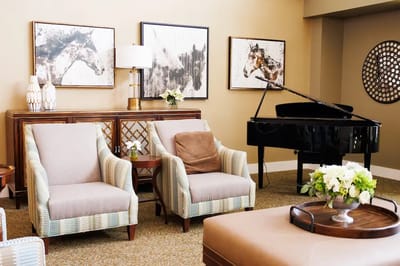 Bright and inviting common area with seating and piano