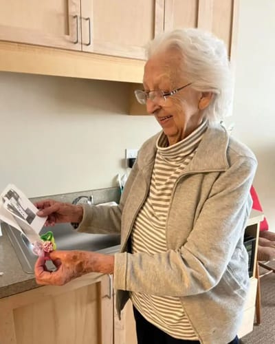 Elderly resident joyfully looking at a photo