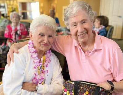 Two smiling residents in a common area