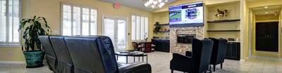 Bright common area with comfortable seating and a TV
