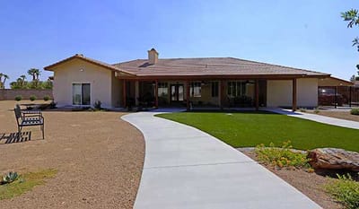 Exterior view of Mimi’s Care Home with pathway and garden
