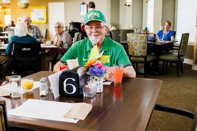 Resident enjoying a meal in the dining room