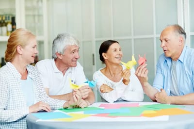 Residents engaged in a craft activity with colorful paper