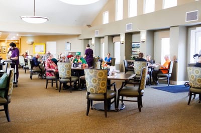 Residents engaged in activities in a dining area
