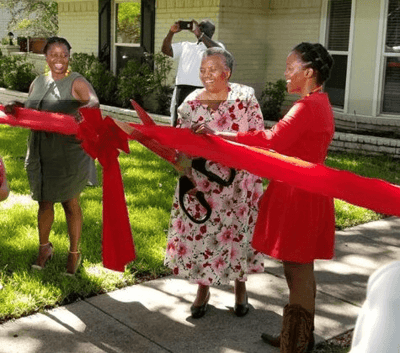 Residents celebrating at a ribbon-cutting ceremony