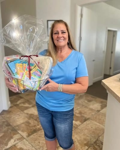 Staff member holding a gift basket in the facility
