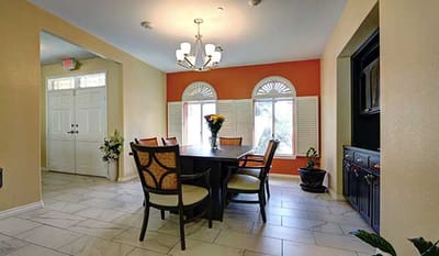 Interior dining room with a large table and windows