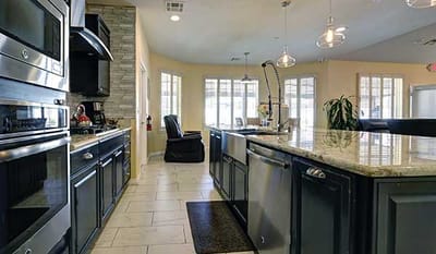 Modern kitchen space with granite countertops and appliances