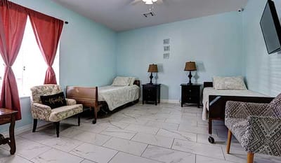 Comfortable resident room with two beds and cozy decor