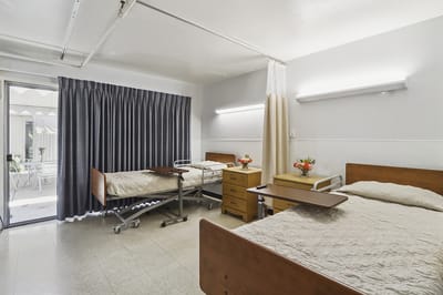 Interior view of a shared resident room with beds and furniture