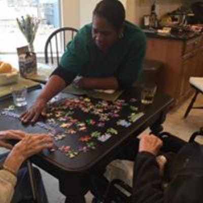 Residents working on a puzzle in a common area
