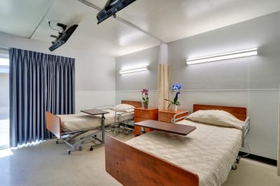 Private resident room with two beds and decor