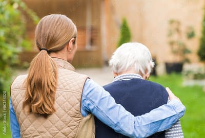 Caregiver with resident in an outdoor garden