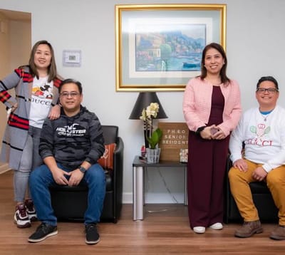 Residents and staff posing in a common area.