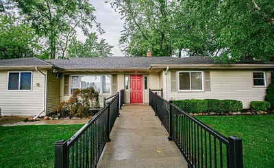 Exterior view of the senior residence with a red door